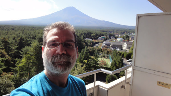 selfie from my hotel room balcony with mount fuji in the background
